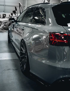 A car is parked in a garage with other cars