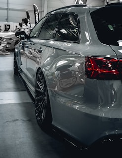 A car is parked in a garage with other cars