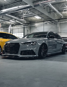 A couple of cars parked inside of a garage
