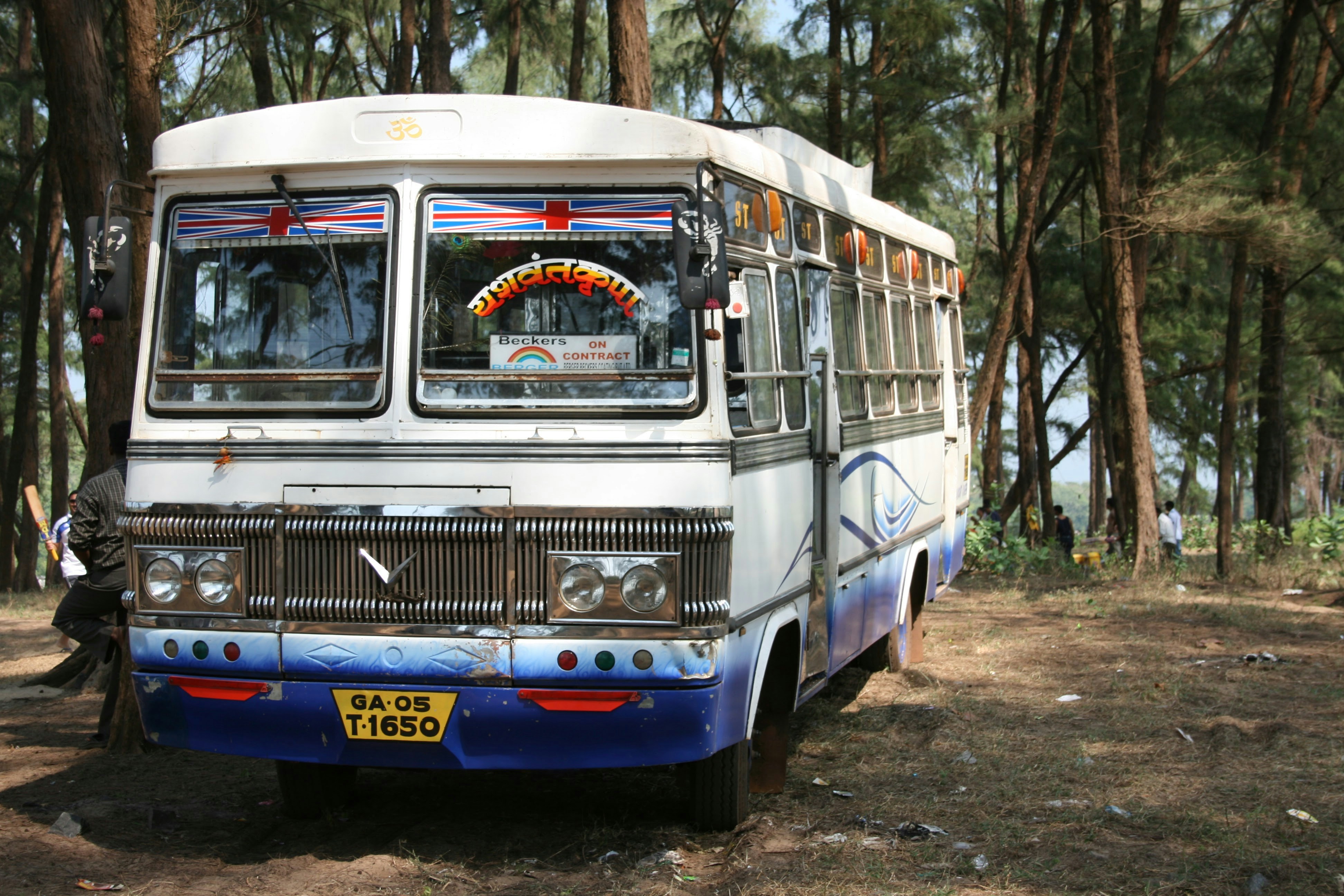 A bus parked in the middle of a forest