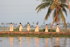 A group of women walking across a river