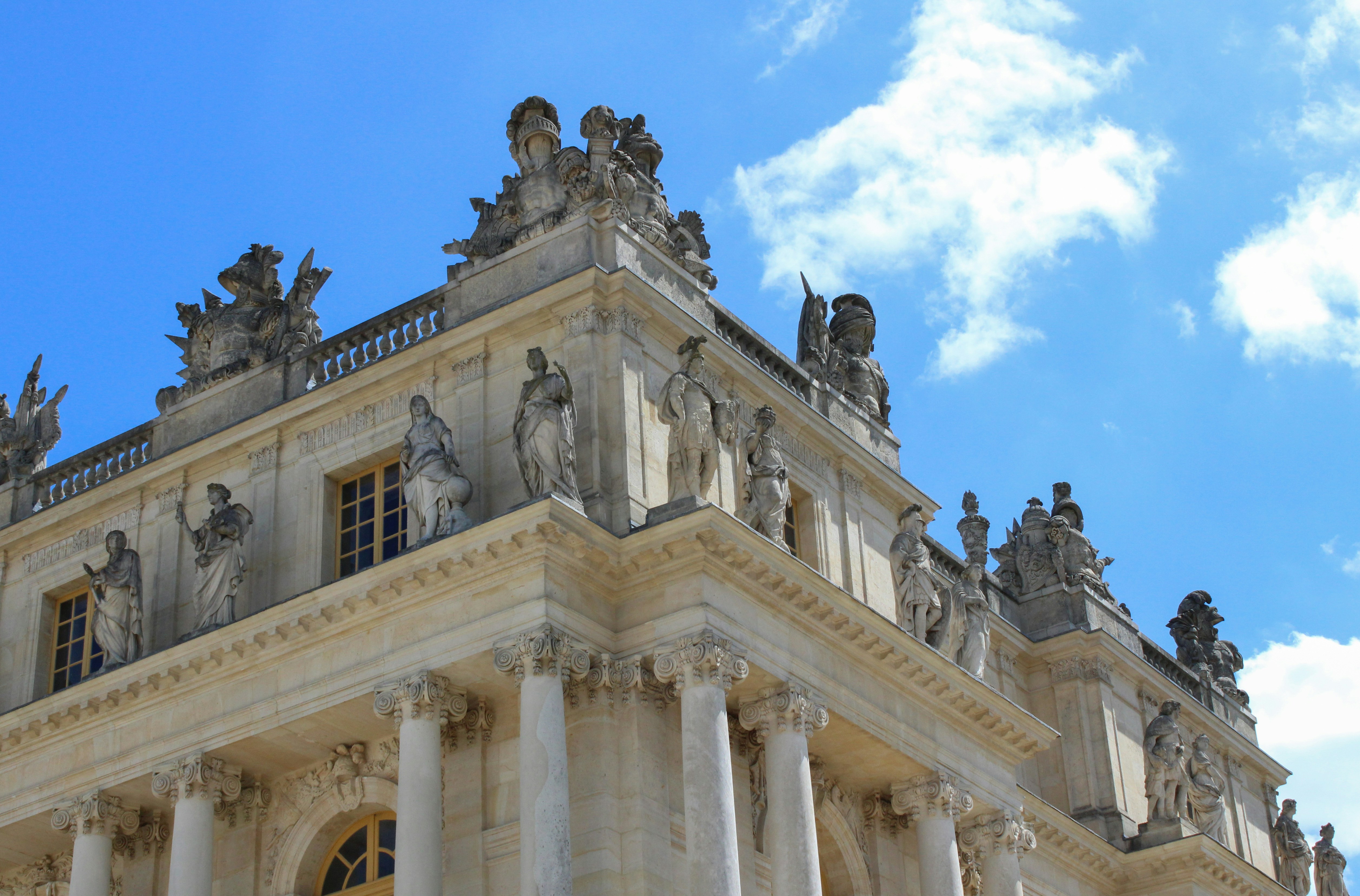 A tall building with statues on top of it