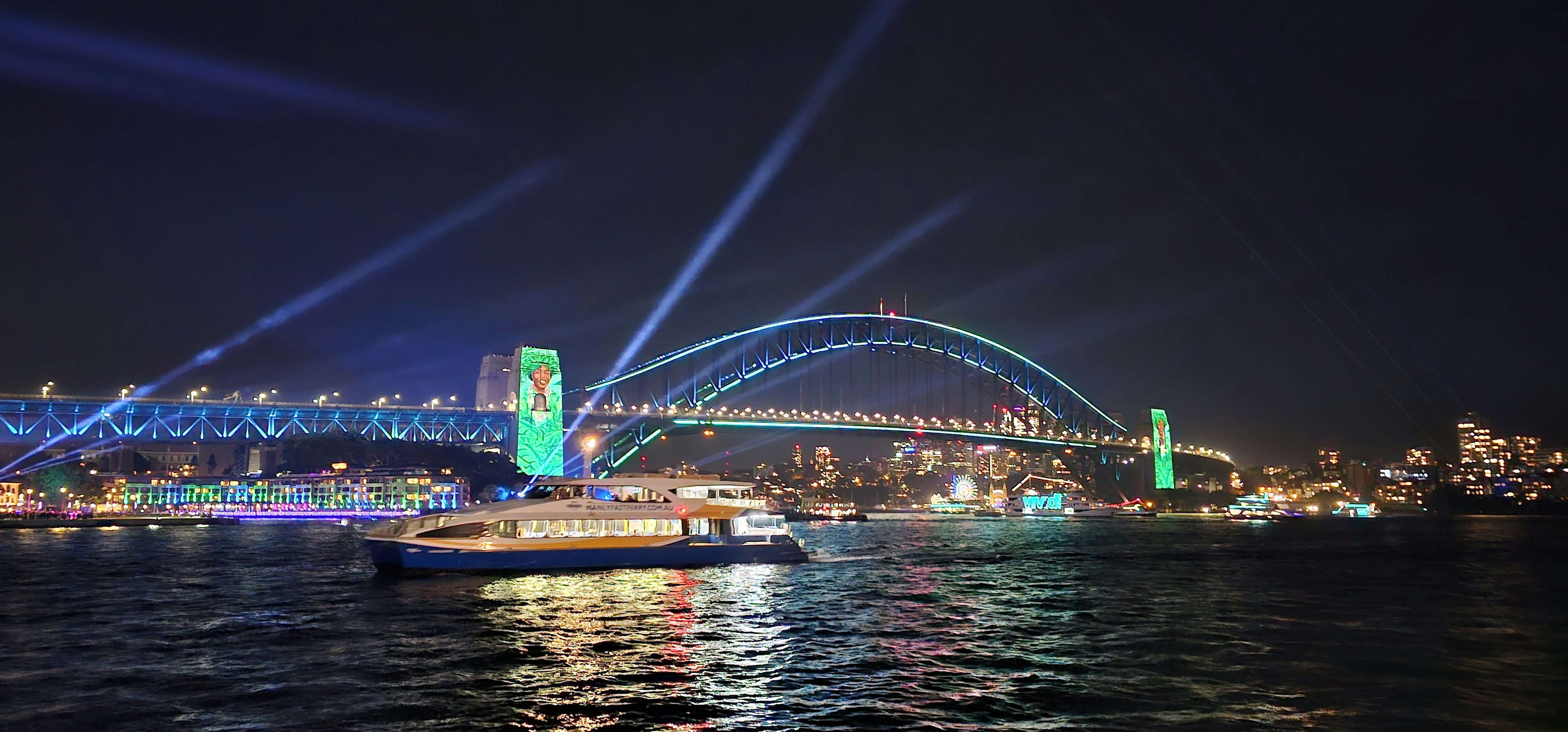 A view of a bridge over a body of water at night