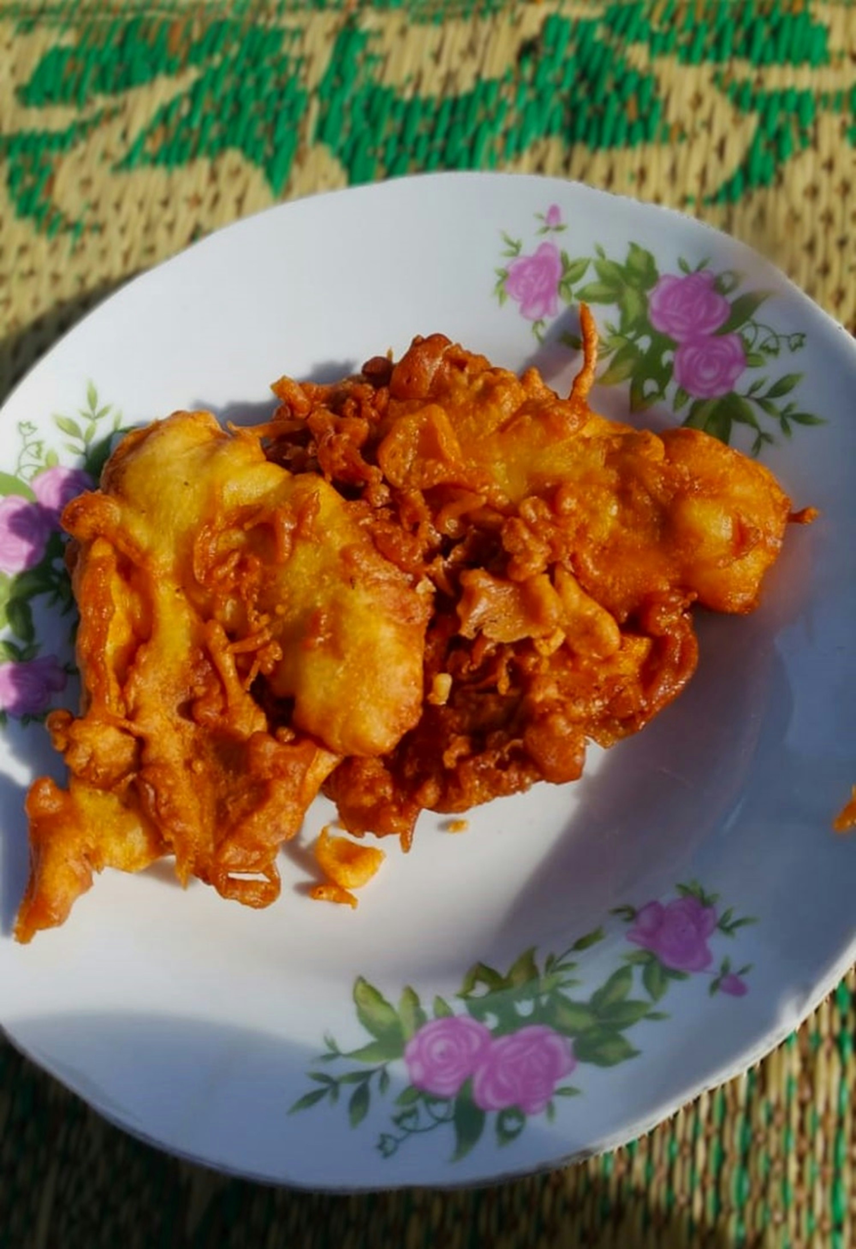 A white plate topped with fried food on top of a table