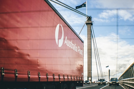 A large red boat sitting on the side of a road