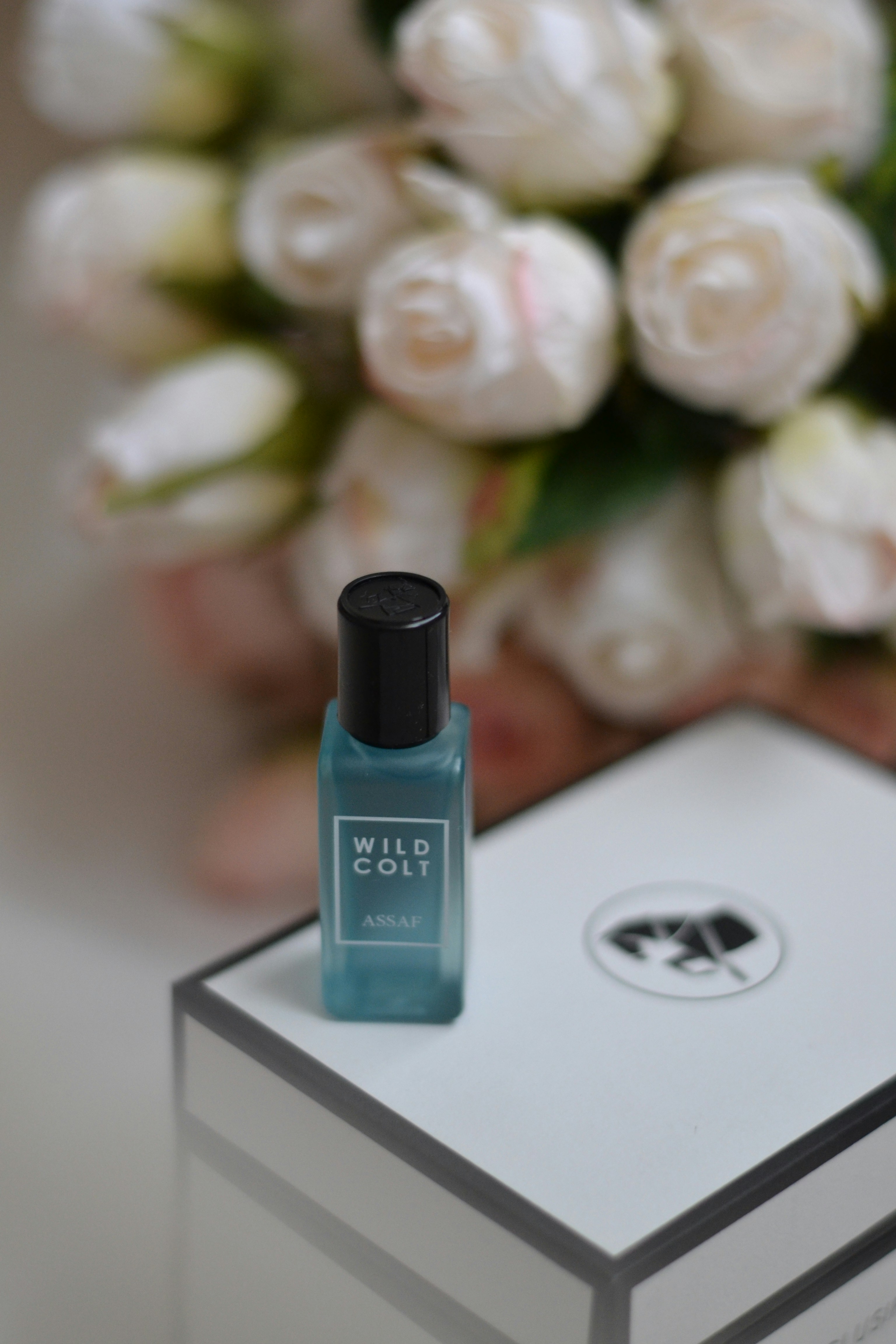 A bottle of nail polish sitting on top of a box