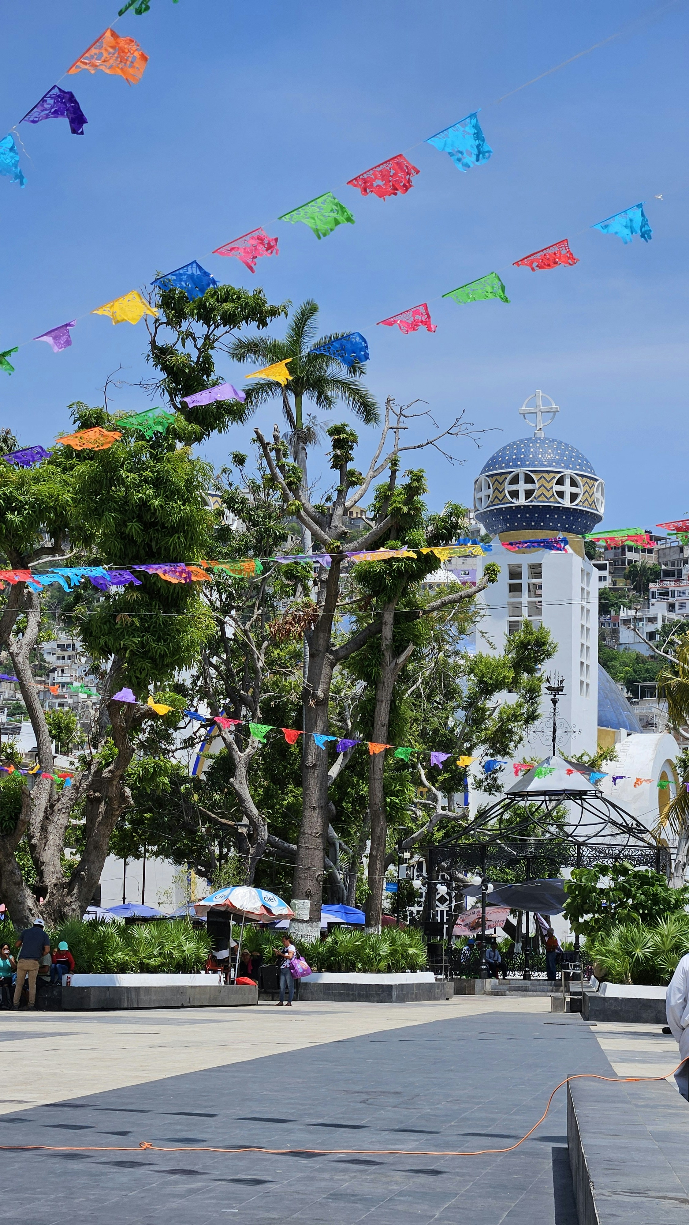 A man walking down a street with a kite in the air
