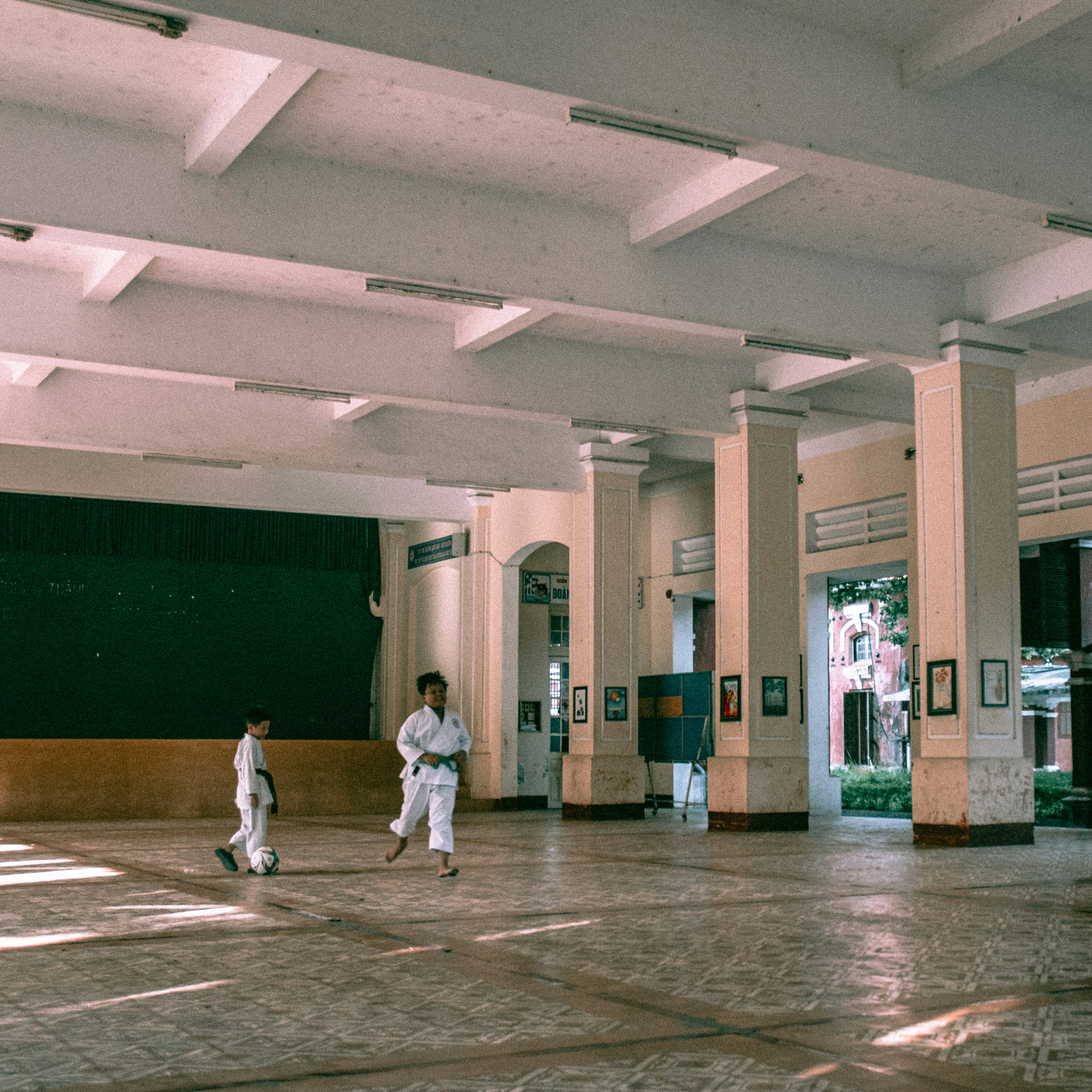 Two people are walking in a large building
