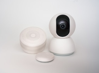 A white camera sitting on top of a white table