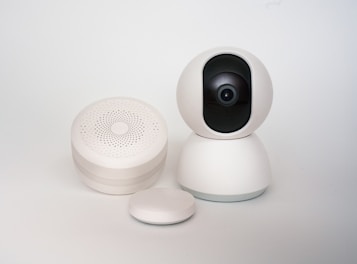 A white camera sitting on top of a white table