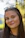 A woman with glasses smiling for the camera