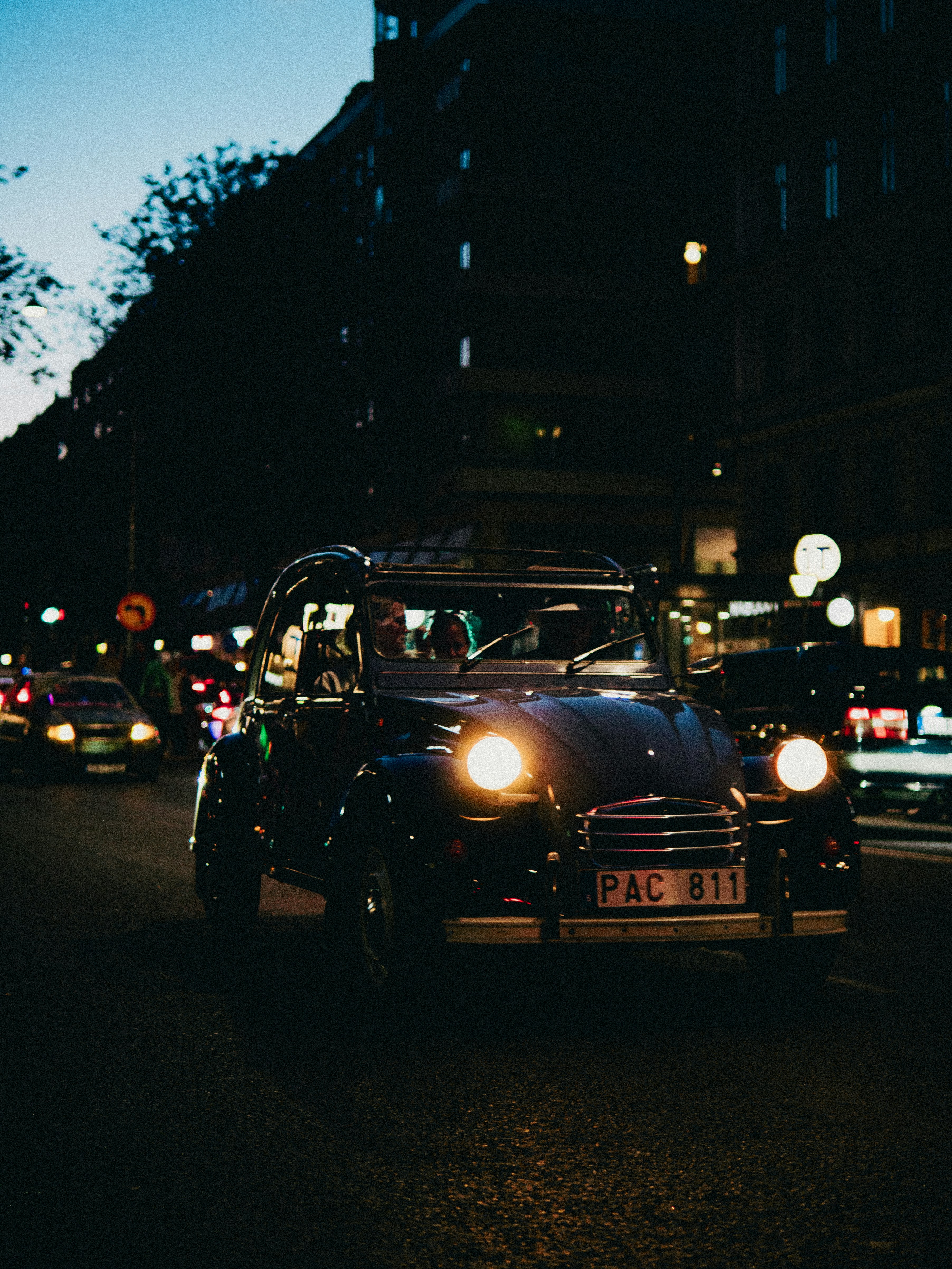 A car driving down a street at night