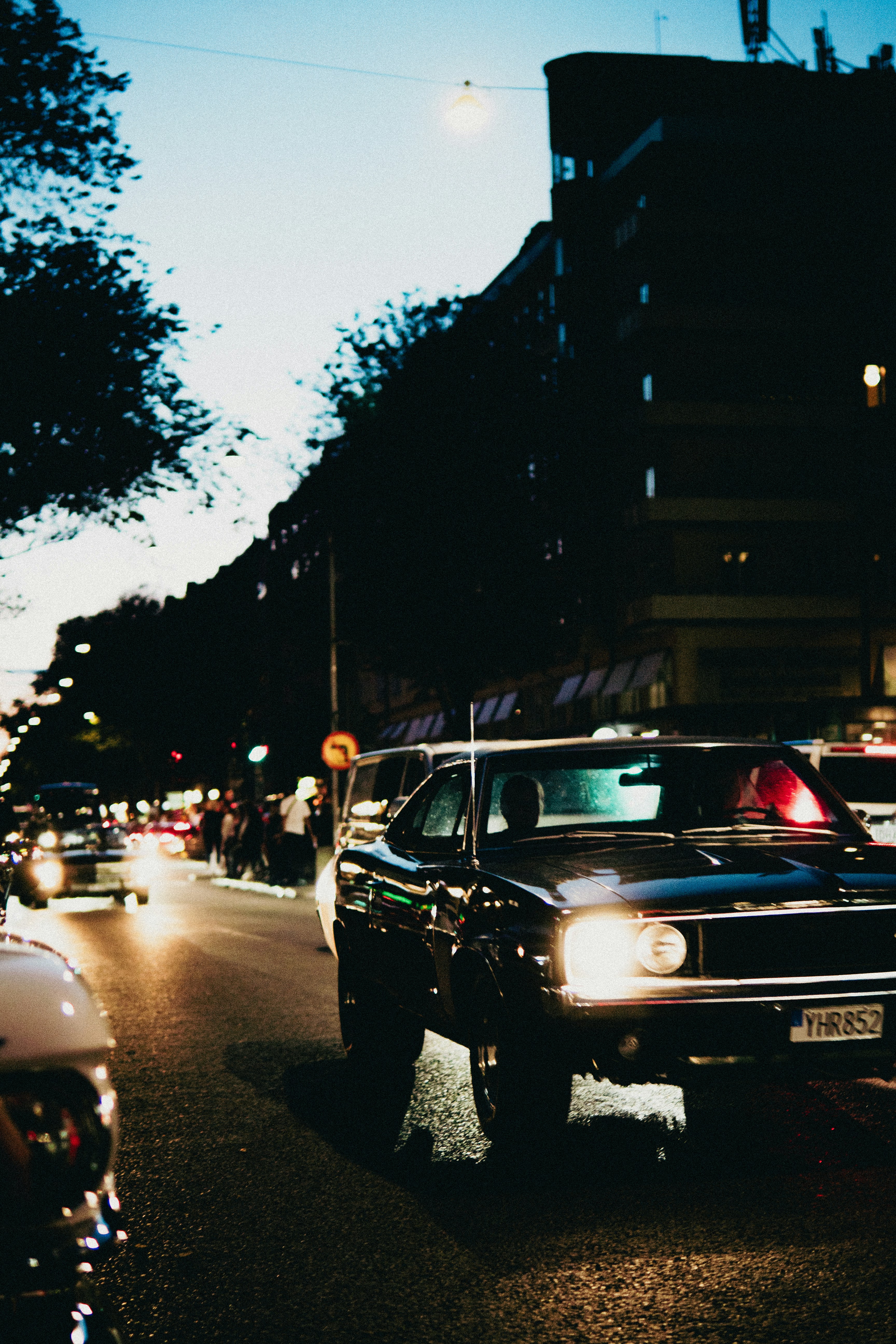 A car driving down a city street at night