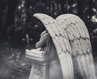 A black and white photo of an angel statue