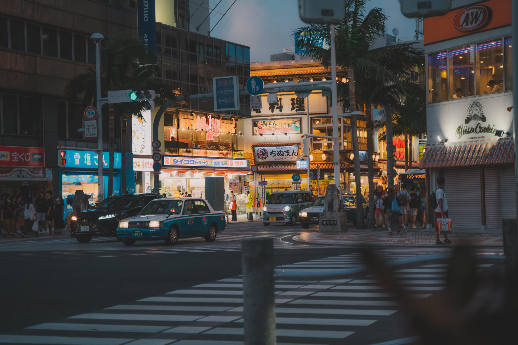 Kokusai-dori in Naha am Abend mit beleuchteten Geschäften und Verkehr