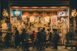 A group of people standing outside of a store