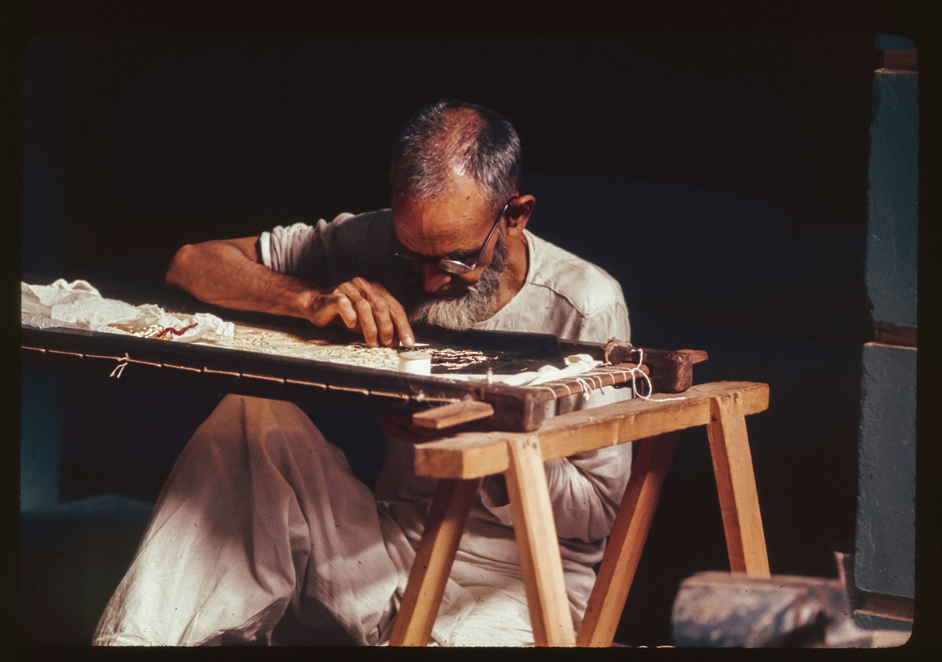 A man sitting at a table playing a musical instrument