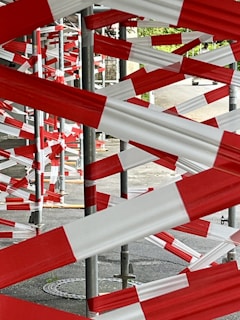 A bunch of red and white barriers in a parking lot