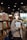 A woman standing in front of a bookshelf holding a book