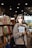 A woman standing in front of a bookshelf holding a book