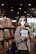 A woman standing in front of a bookshelf holding a book