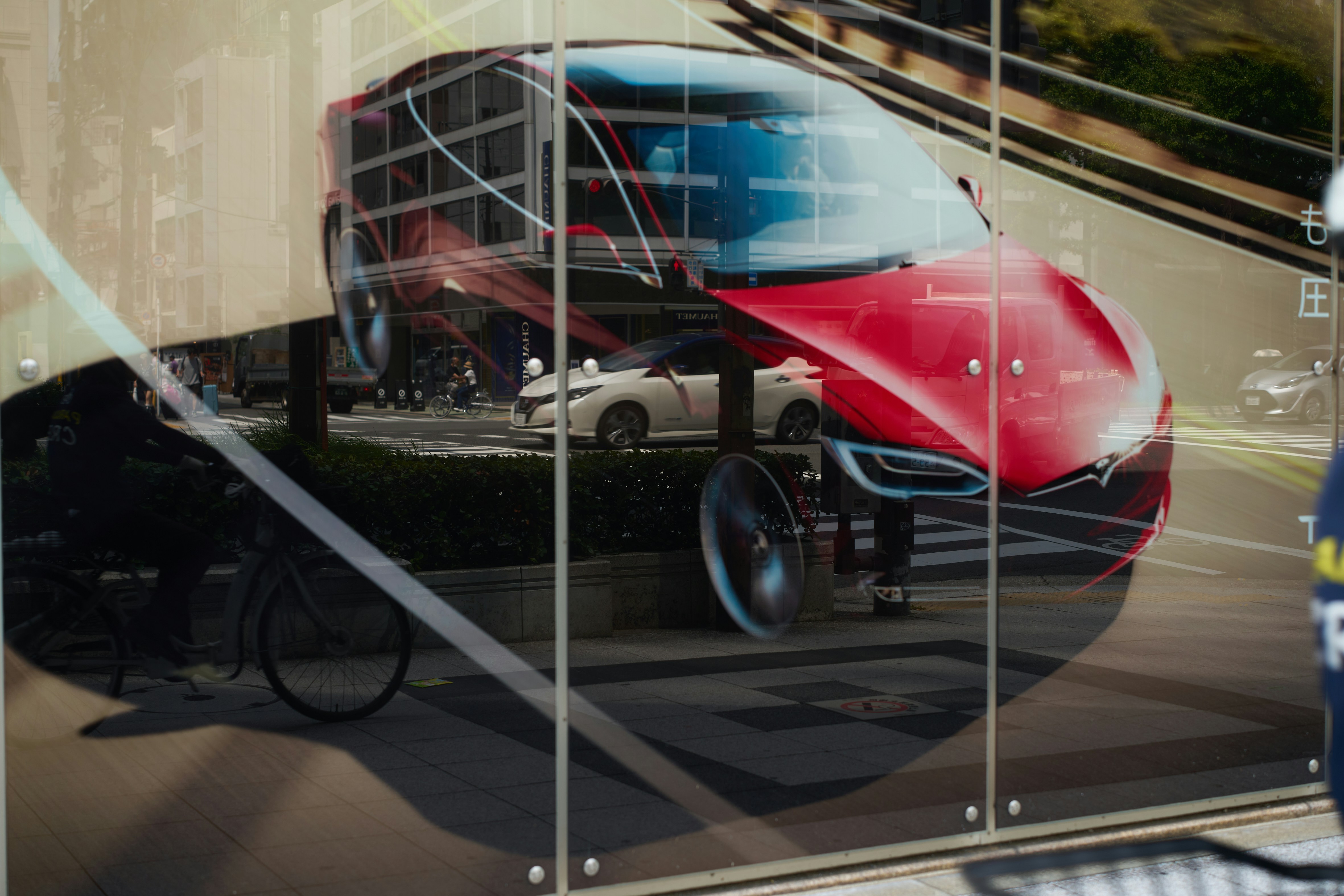 A reflection of a car in a glass window