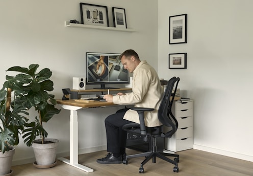 A man sitting at a desk in front of a computer