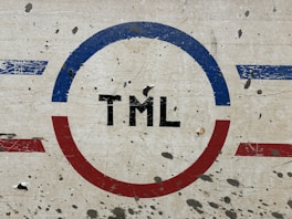 A close up of a sign with a red, white, and blue circle