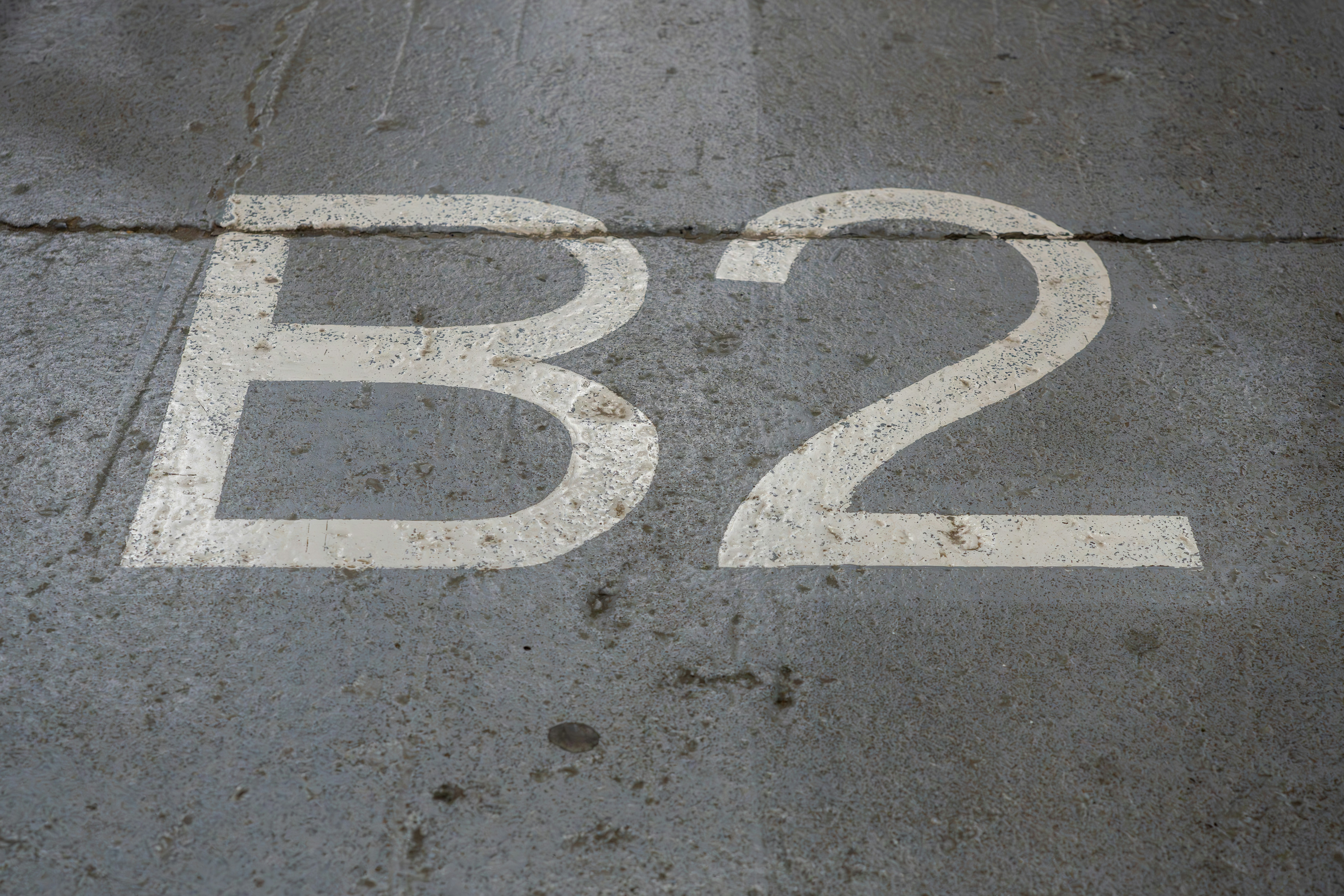 A white b2 sign sitting on top of a sidewalk