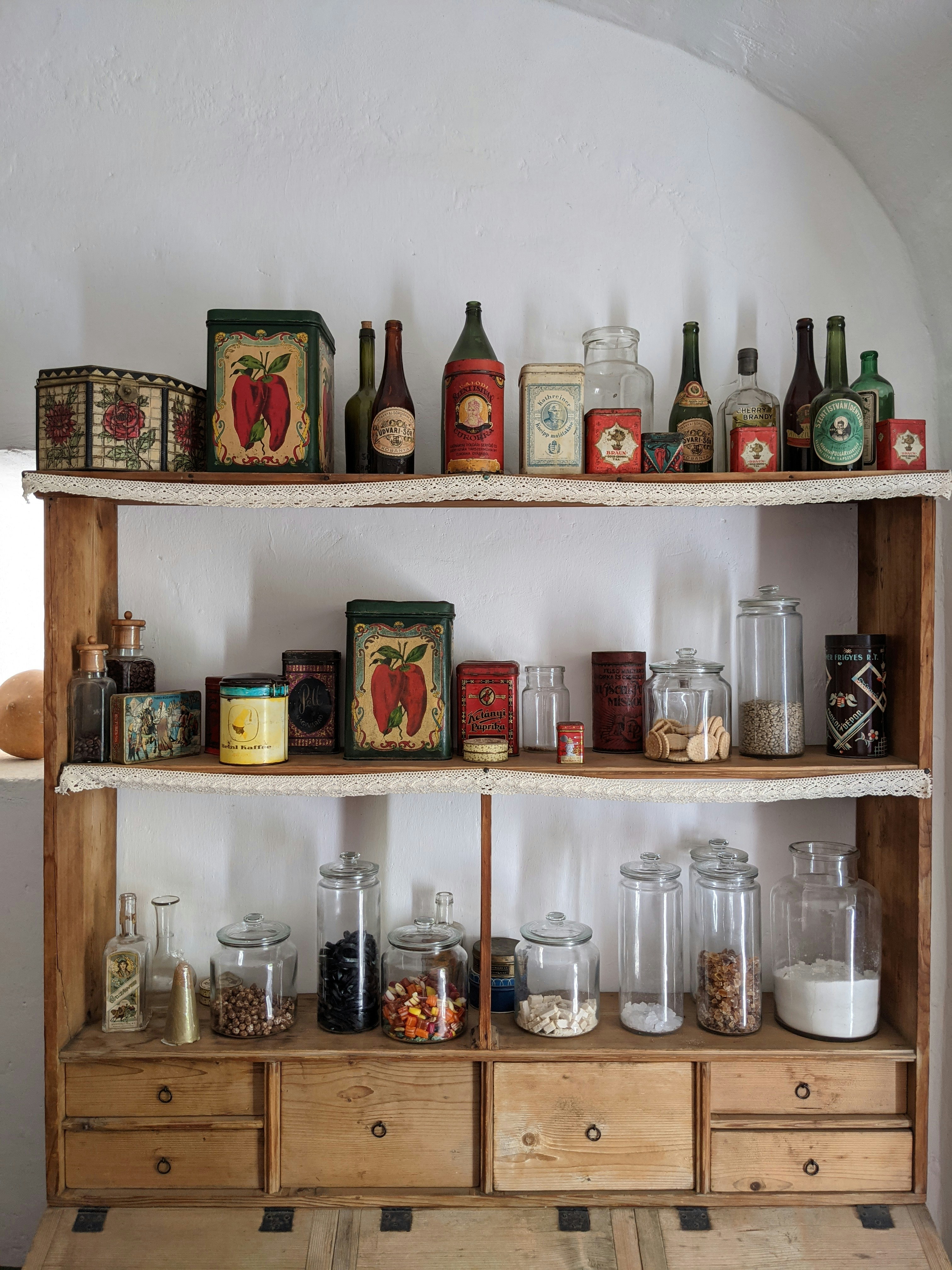 A wooden shelf filled with lots of bottles