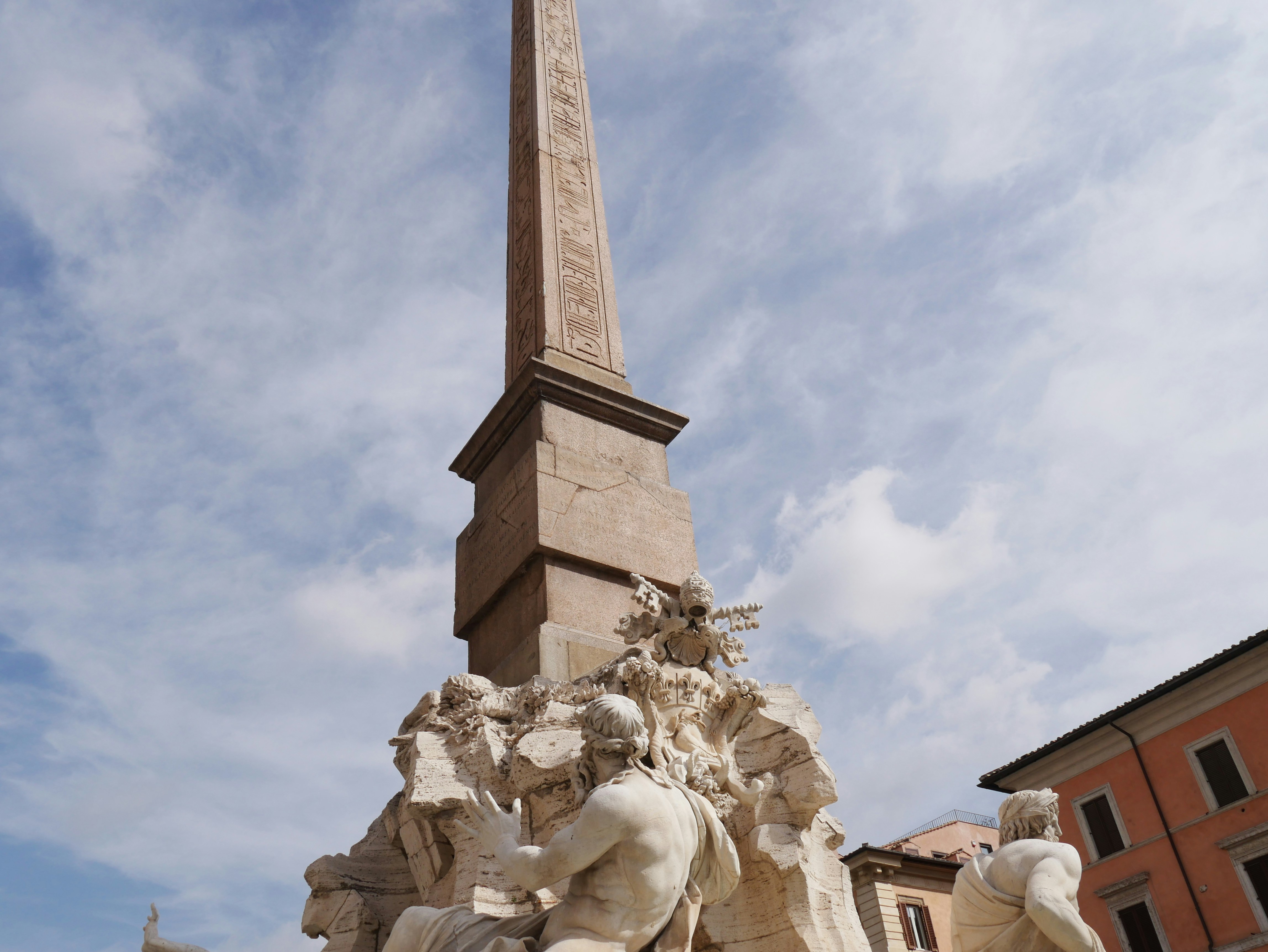 A monument with a clock tower in the background