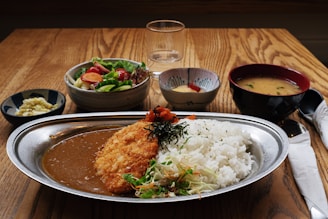 A wooden table topped with a plate of food