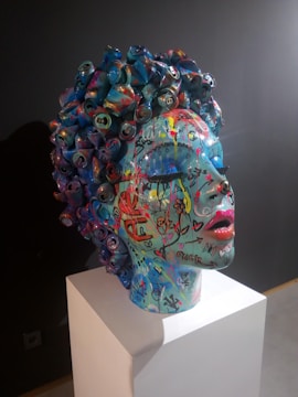 A sculpture of a woman's head with colorful hair