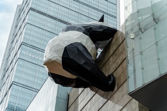 A sculpture of a man hanging from the side of a building
