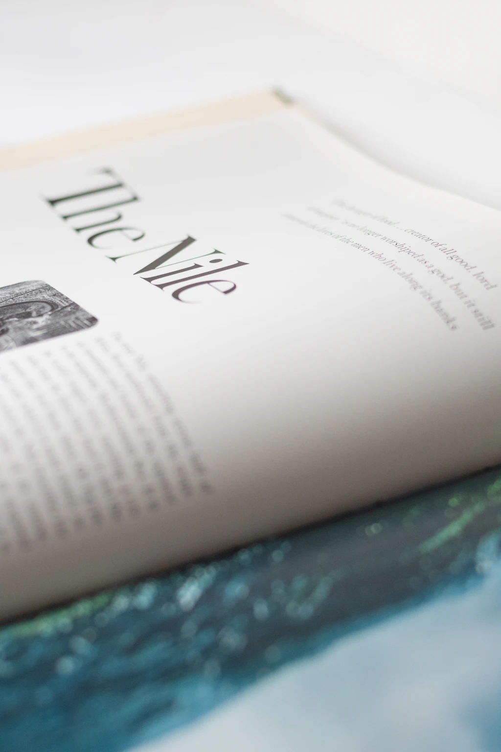 Magazines lay open on a dark wooden desk.