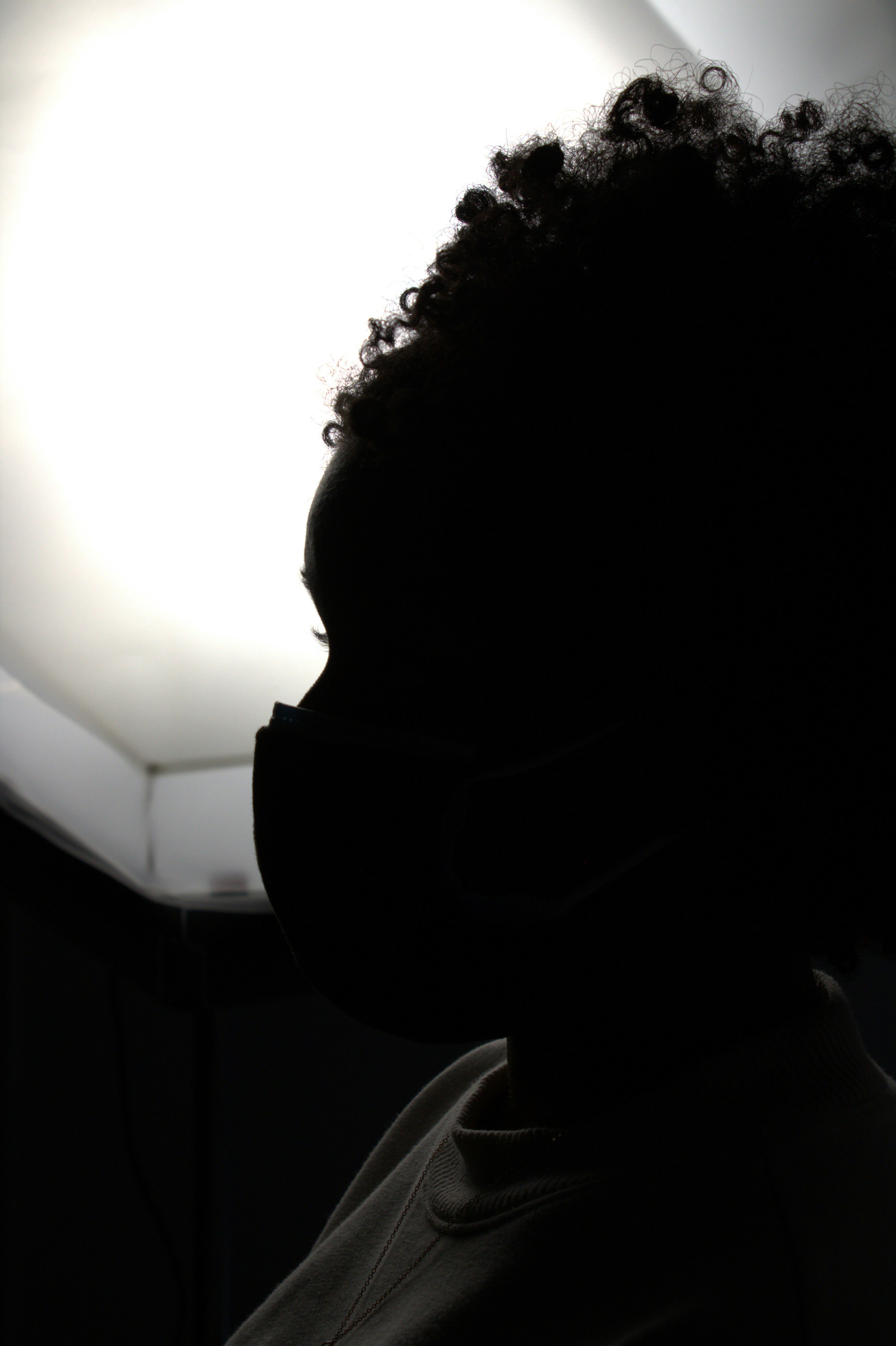 A silhouette of a person wearing a face mask
