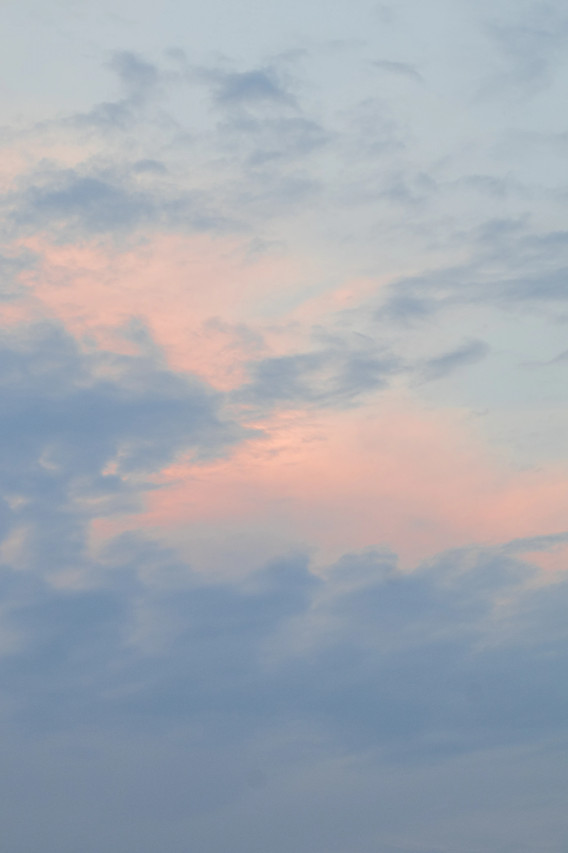 A plane flying in the sky at sunset