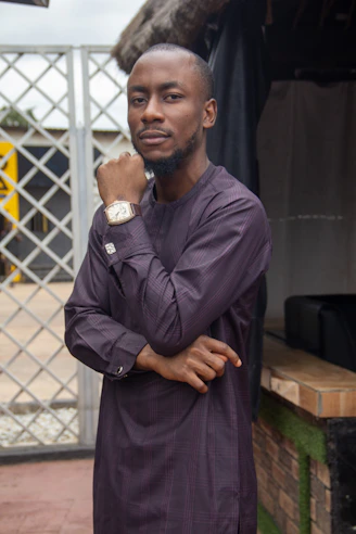 A man standing in front of a fence