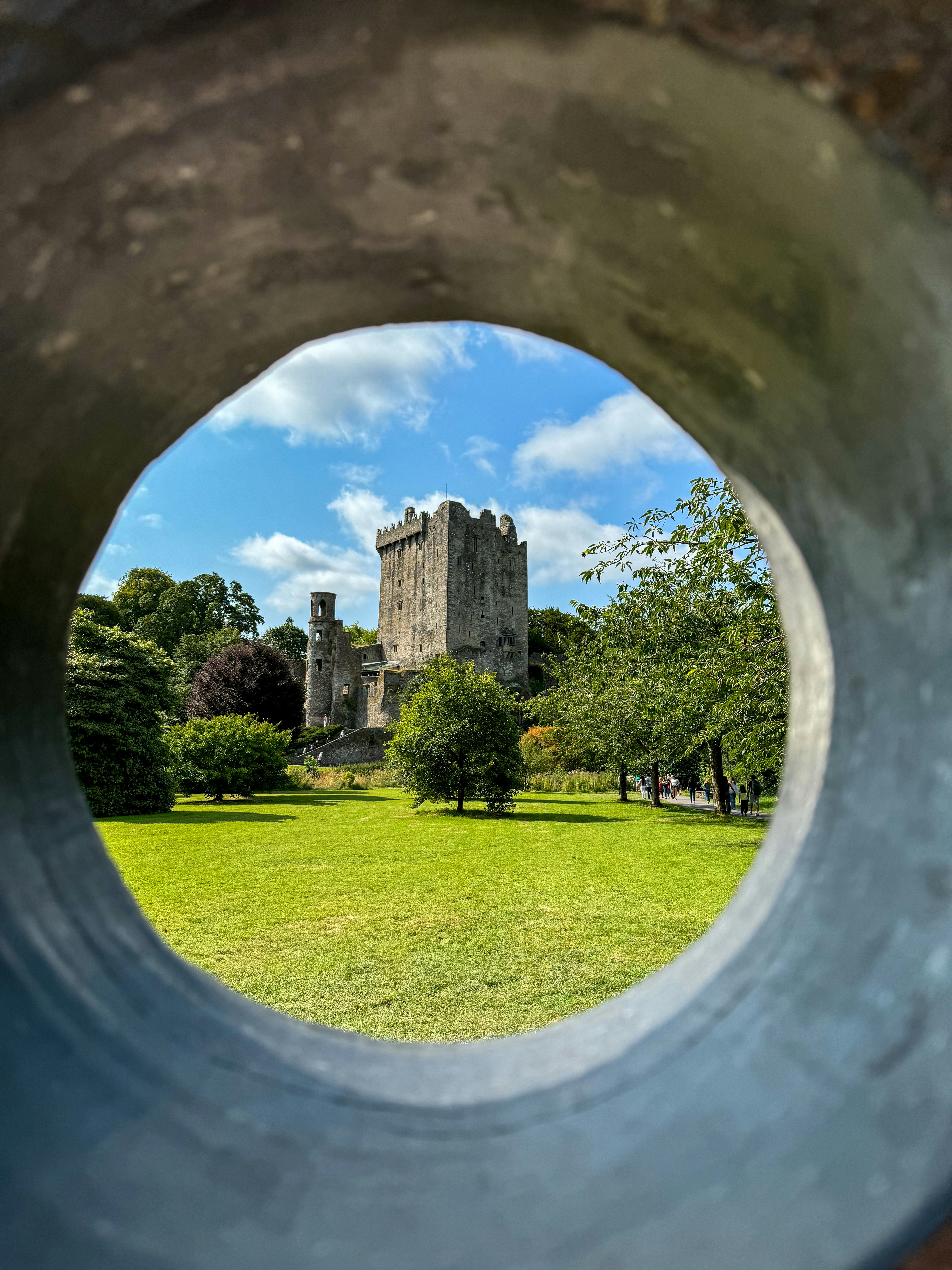 A view of a castle through a hole in a pipe