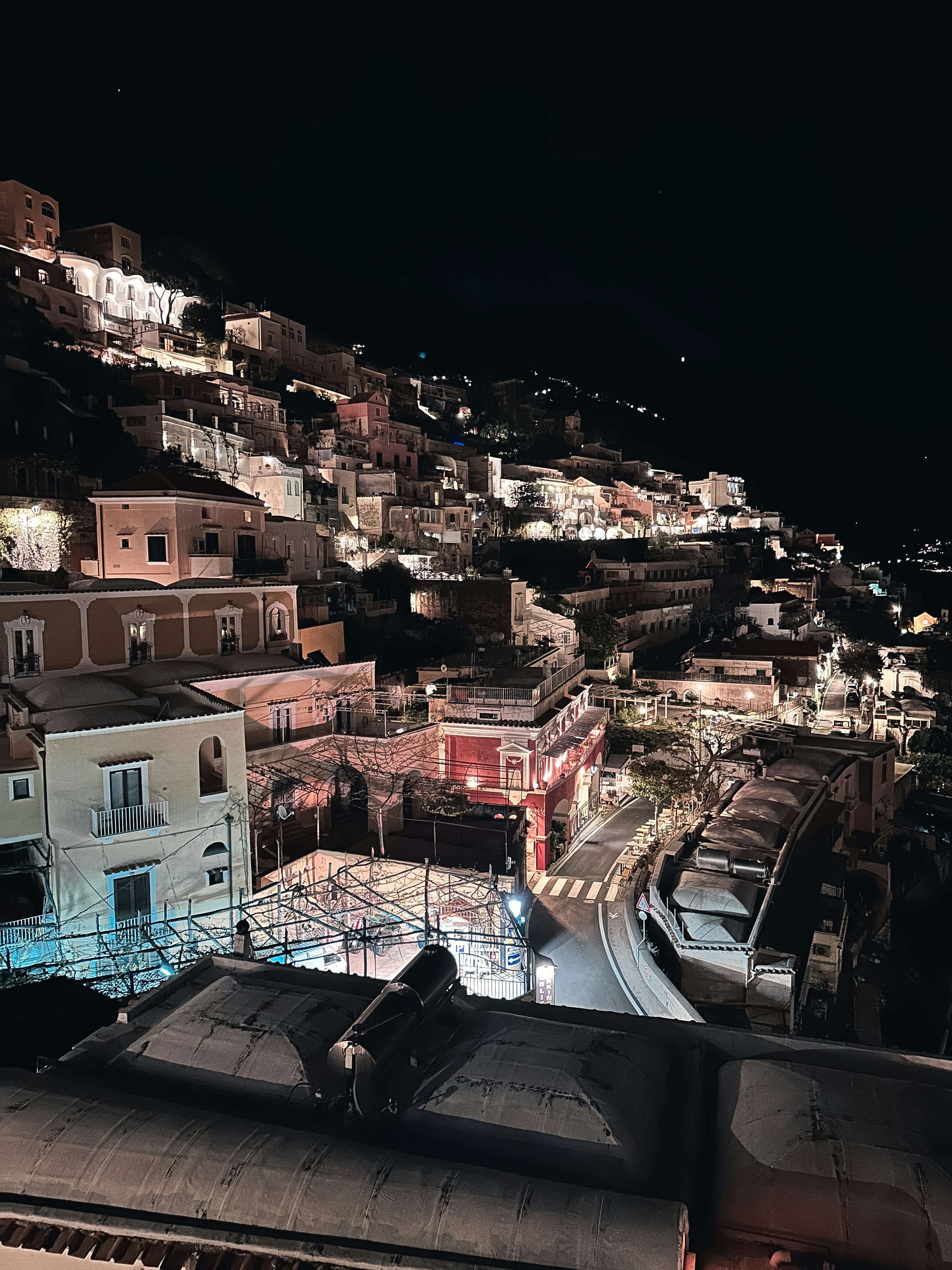 A view of a city at night from a rooftop