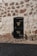 A black door on the side of a stone building