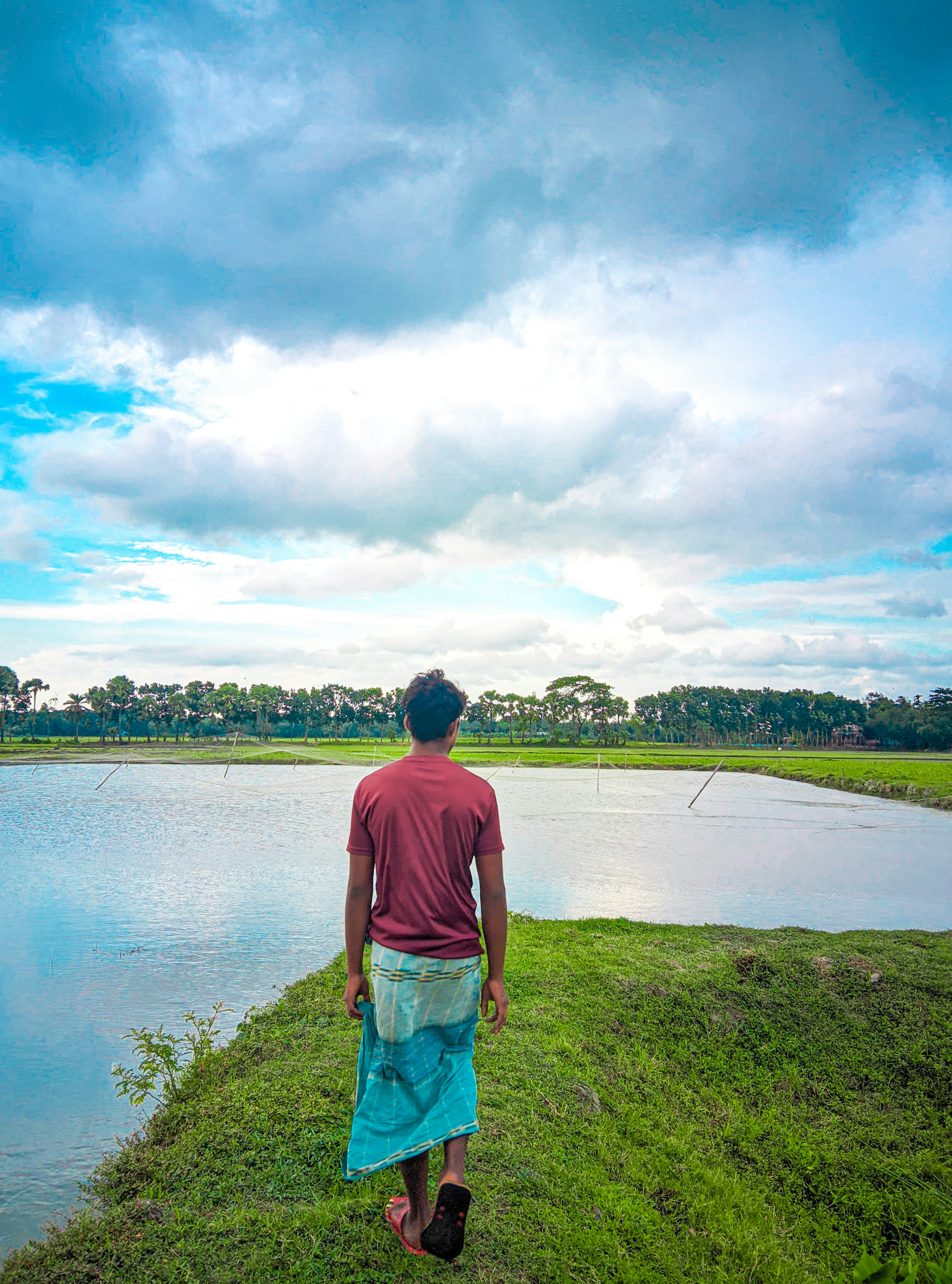A man standing next to a body of water