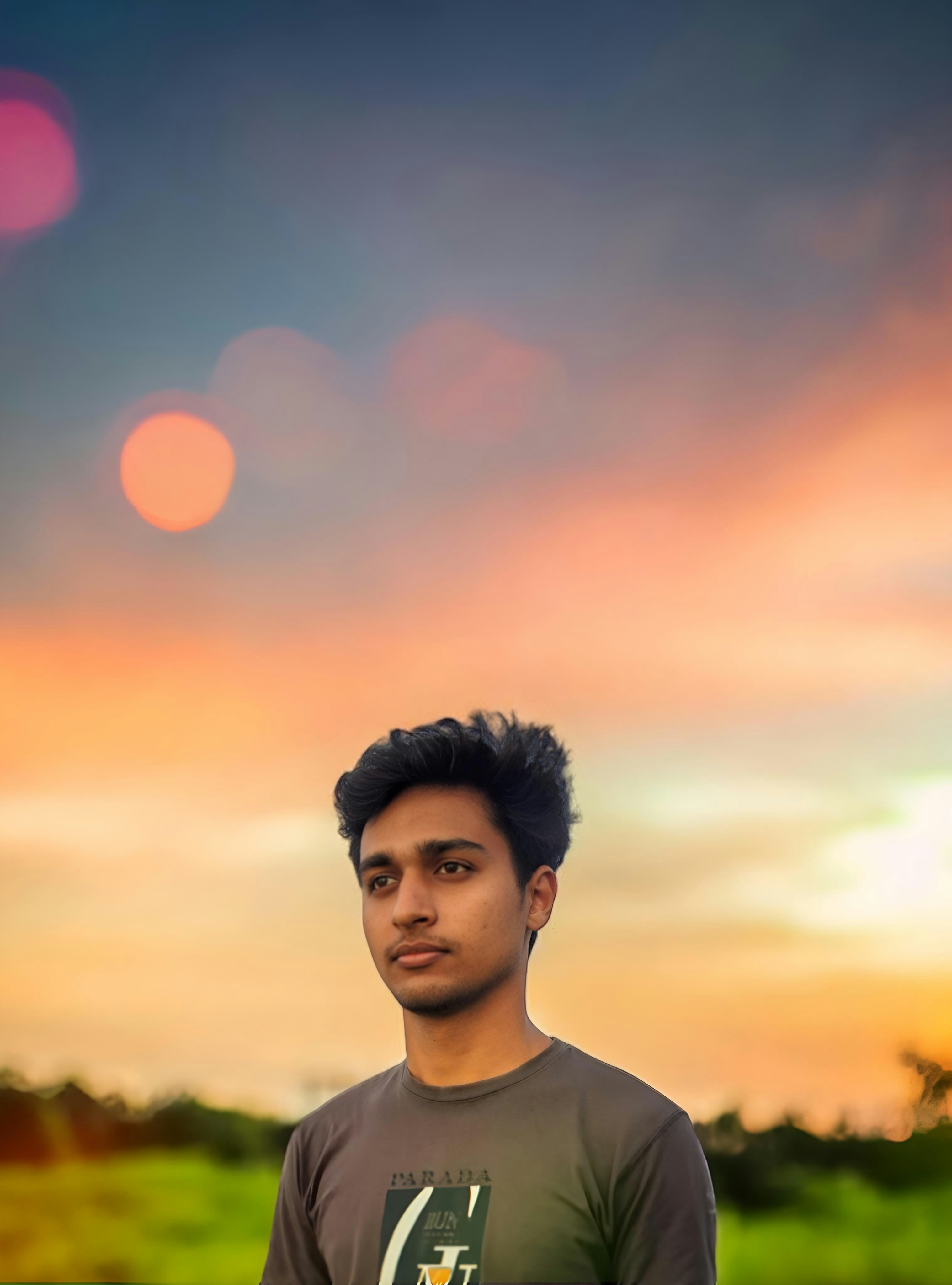 A man standing in front of a sunset