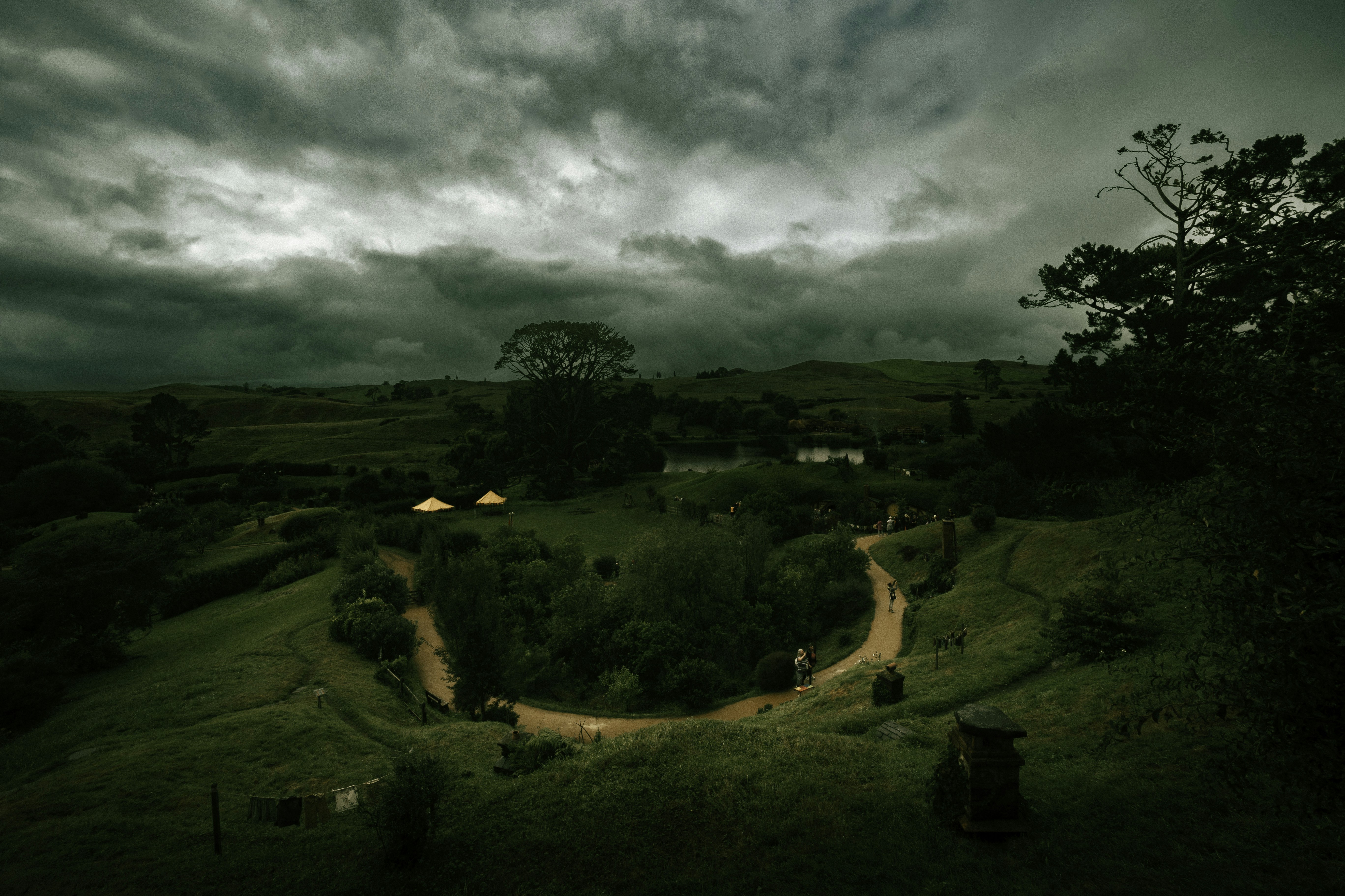 A lush green hillside under a cloudy sky