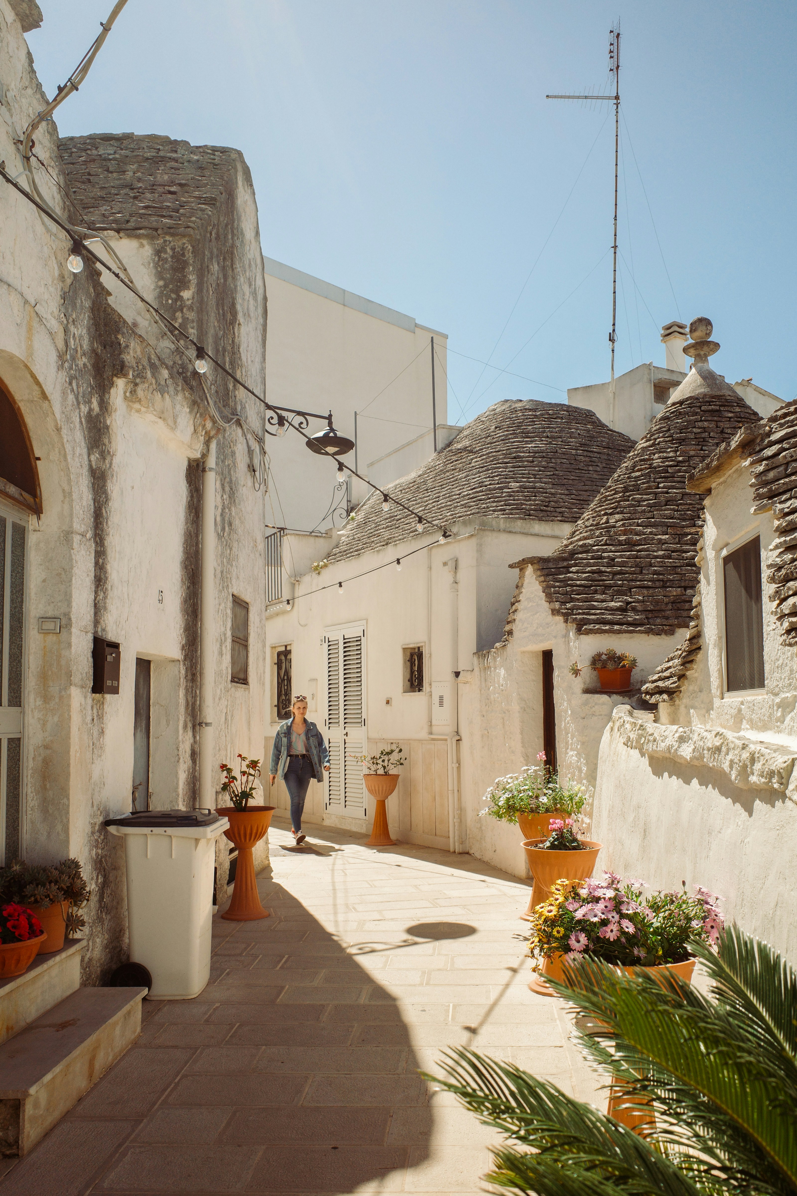 A man walking down a street next to a building