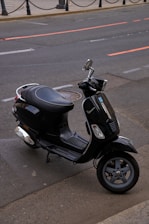 A motor scooter parked on the side of the road