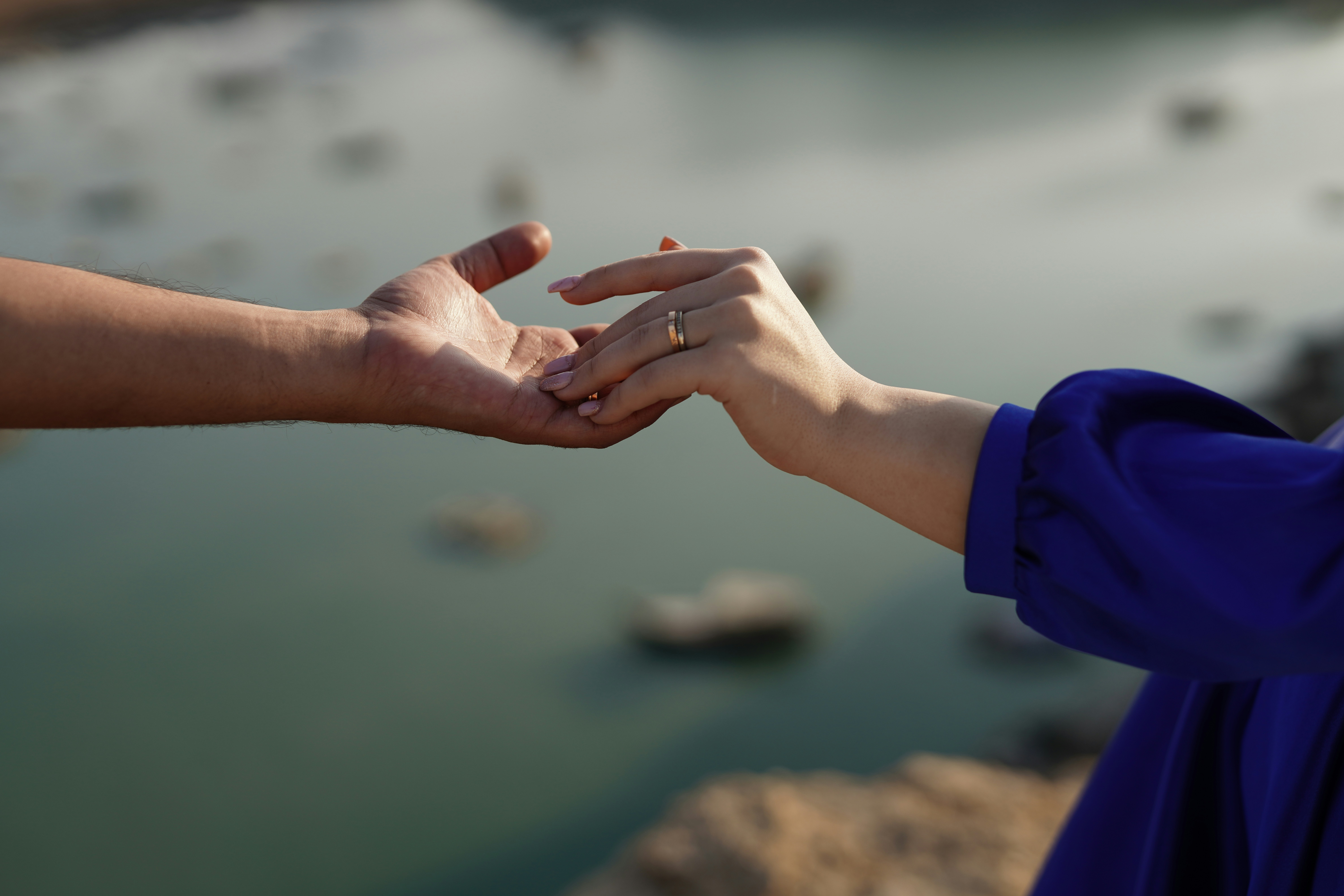 Two people reaching out their hands to each other