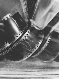 Developed strips of 35mm film curling across a light table