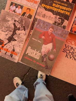 A person standing next to a bunch of books