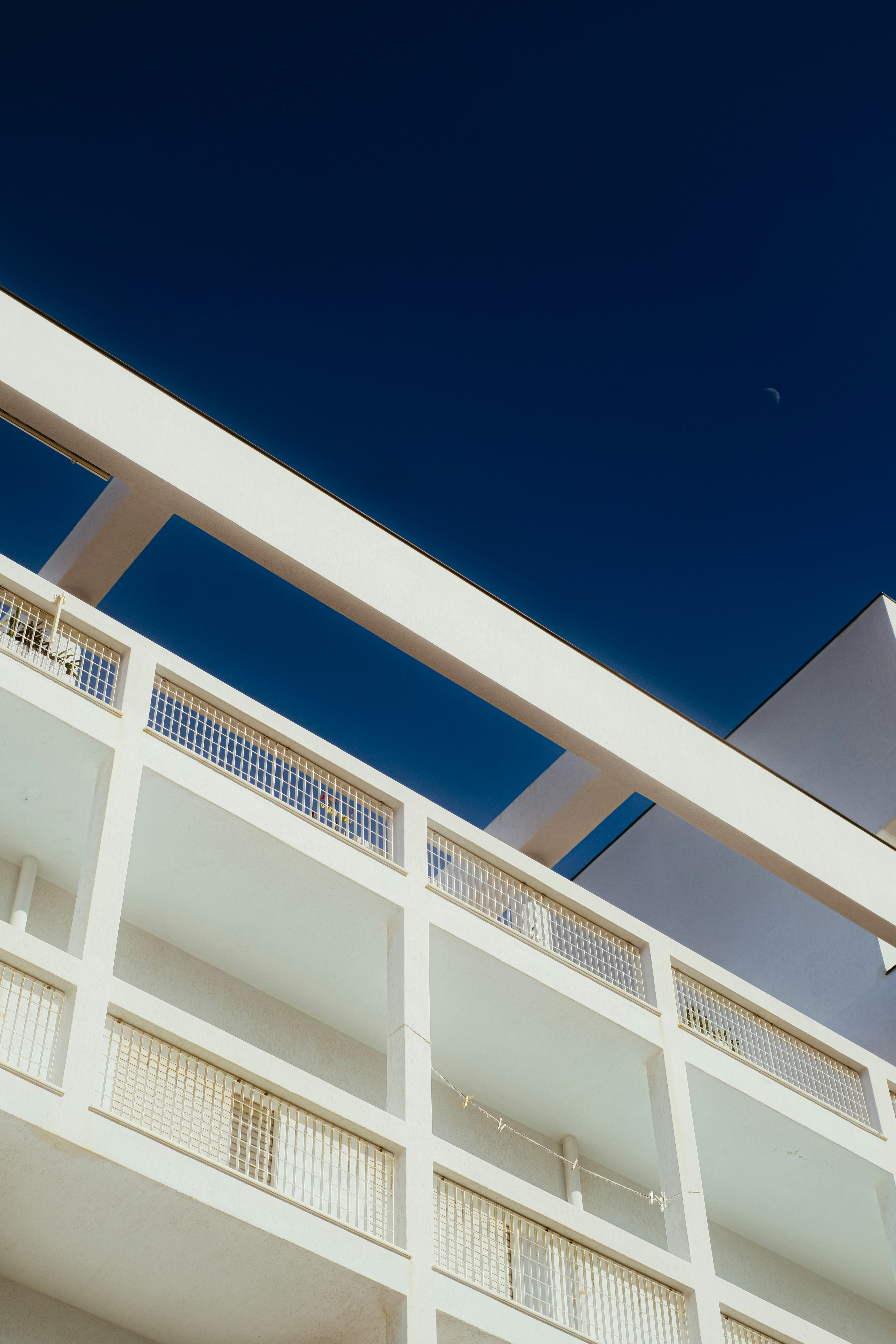 A tall white building with a clock on the top of it